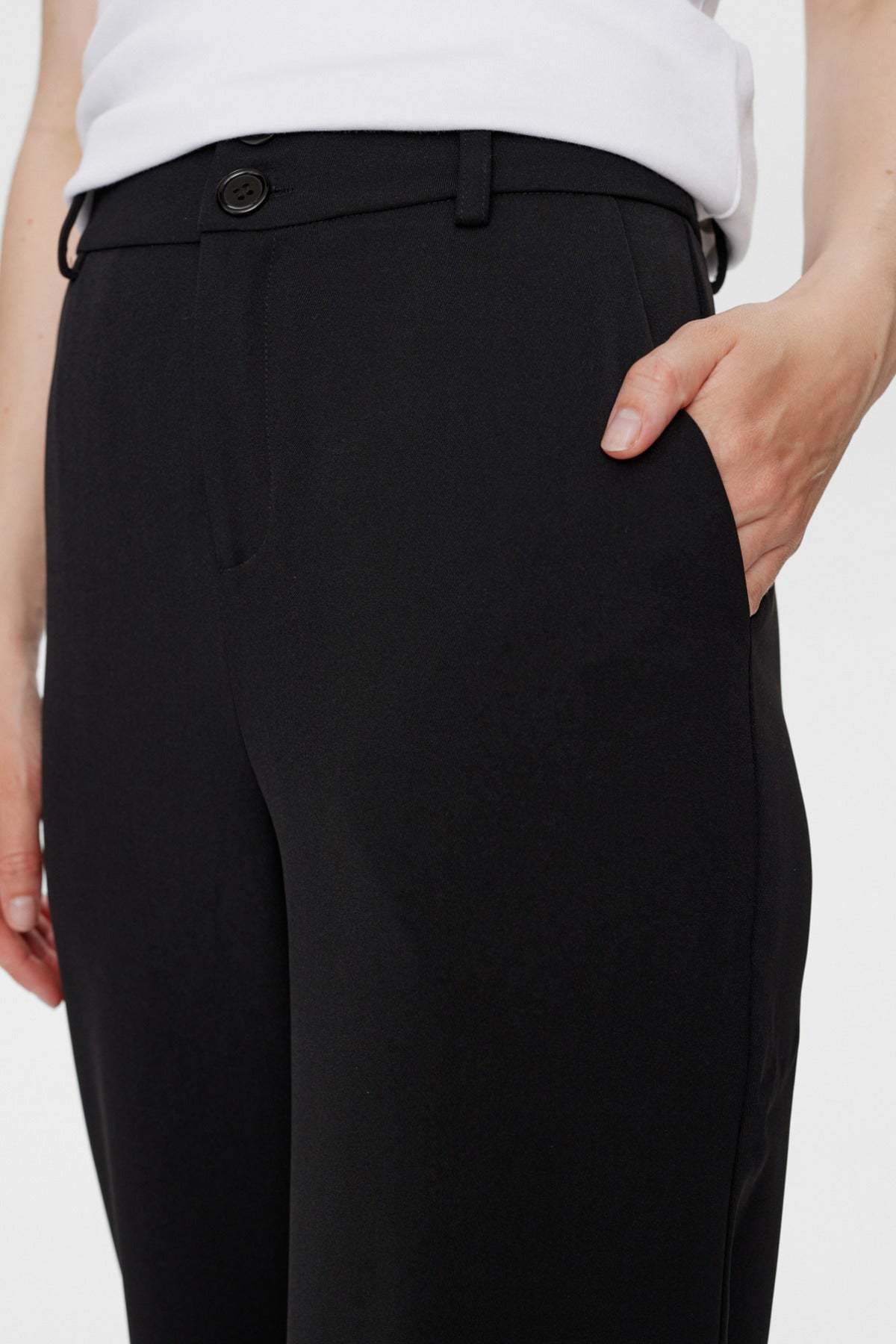 Sorte, slim fit bukser med knap og bæltestropper, lomme og glat stof.