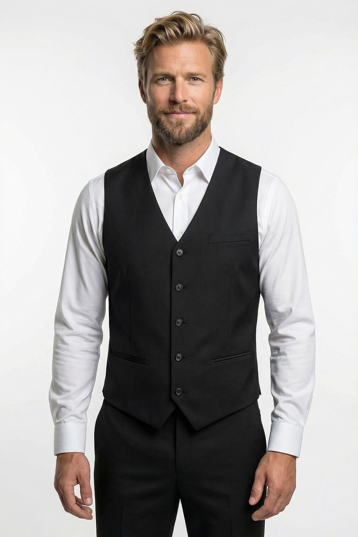 Sort klassisk vest med paspolerede lommer og knapper, båret over hvid skjorte.