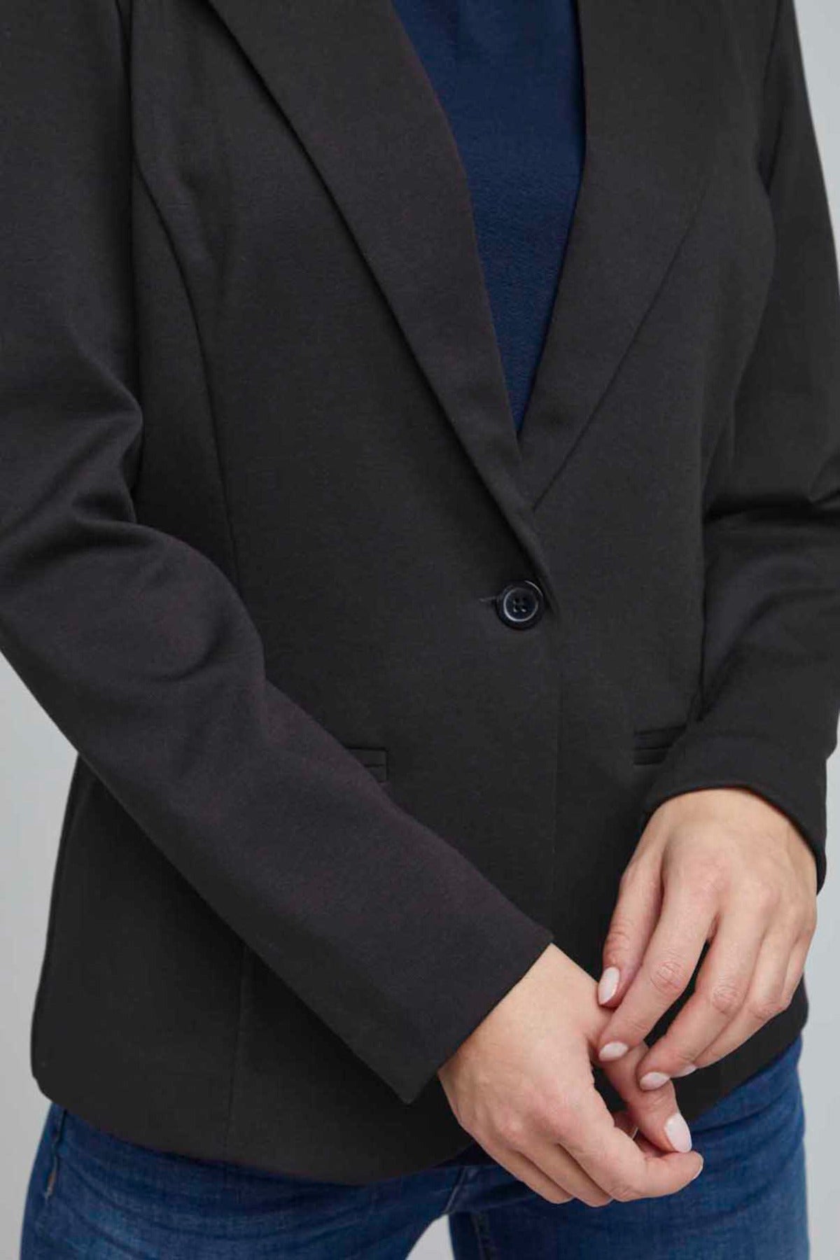 Sort klassisk blazer i regular fit med enkelt knaplukning og let markerede skuldre.