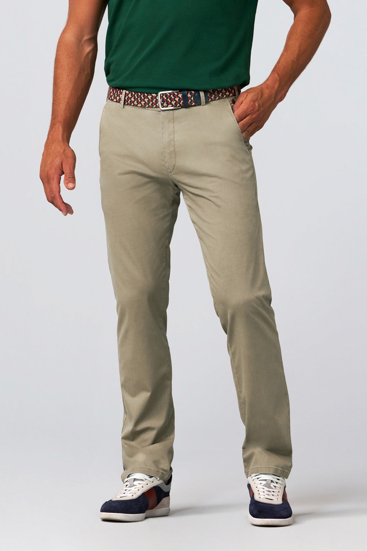 Sandfarvede regular fit chinos med lommer og bæltestropper, stylet med flettet bælte og navy sneakers.