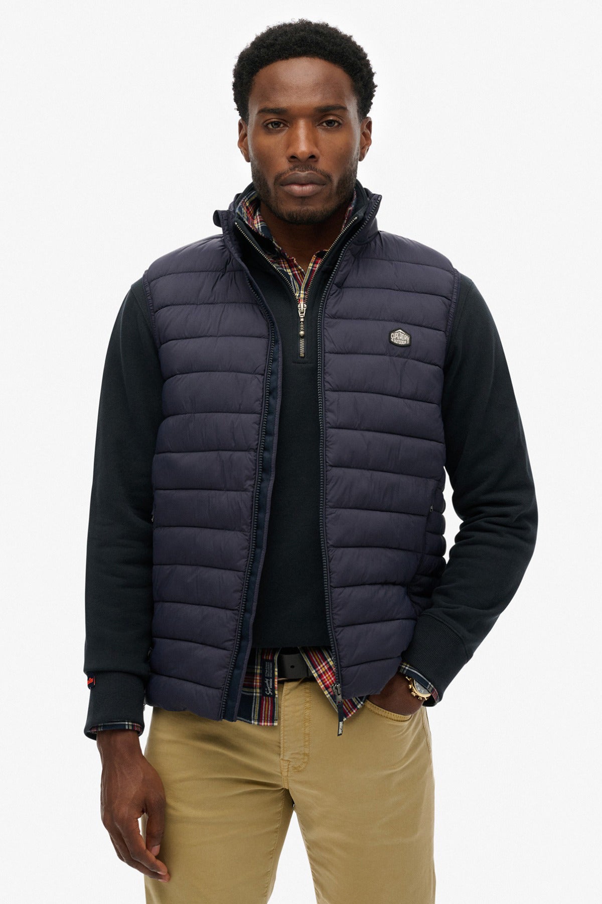 Mørkeblå quiltet og polstret herrevest med ståkrave og lynlås foran i casual stil.