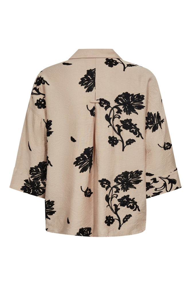 Beige skjortebluse med sorte blomsterprint og trekvartærmer, løs pasform.