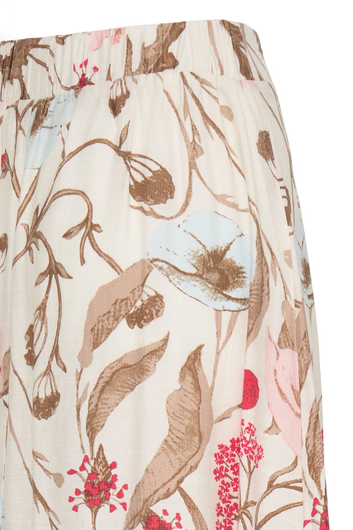 Lang nederdel med slids i beige med blomsterprint i brun, lyseblå og pink.