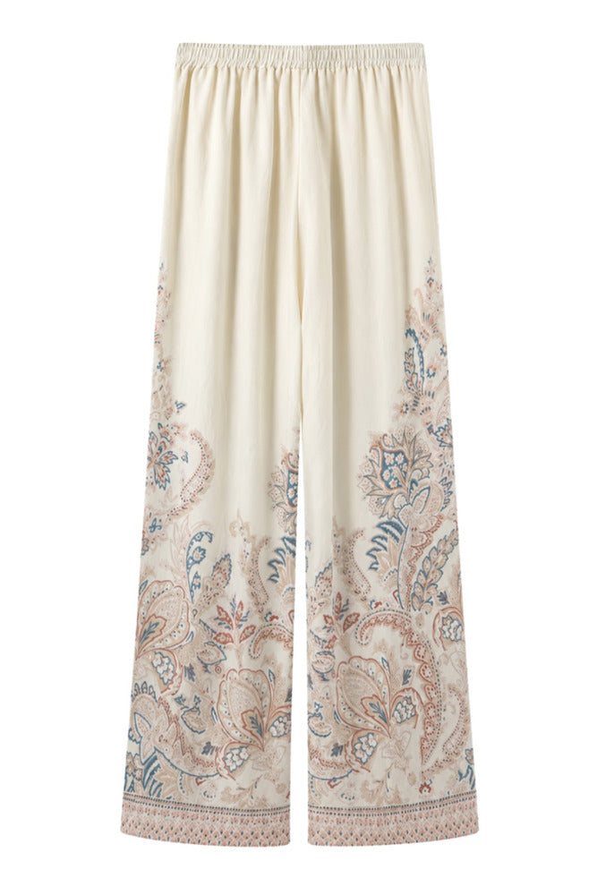 Løse off-white bukser i hør med elastisk talje og farverigt paisley-print ved benkanterne.