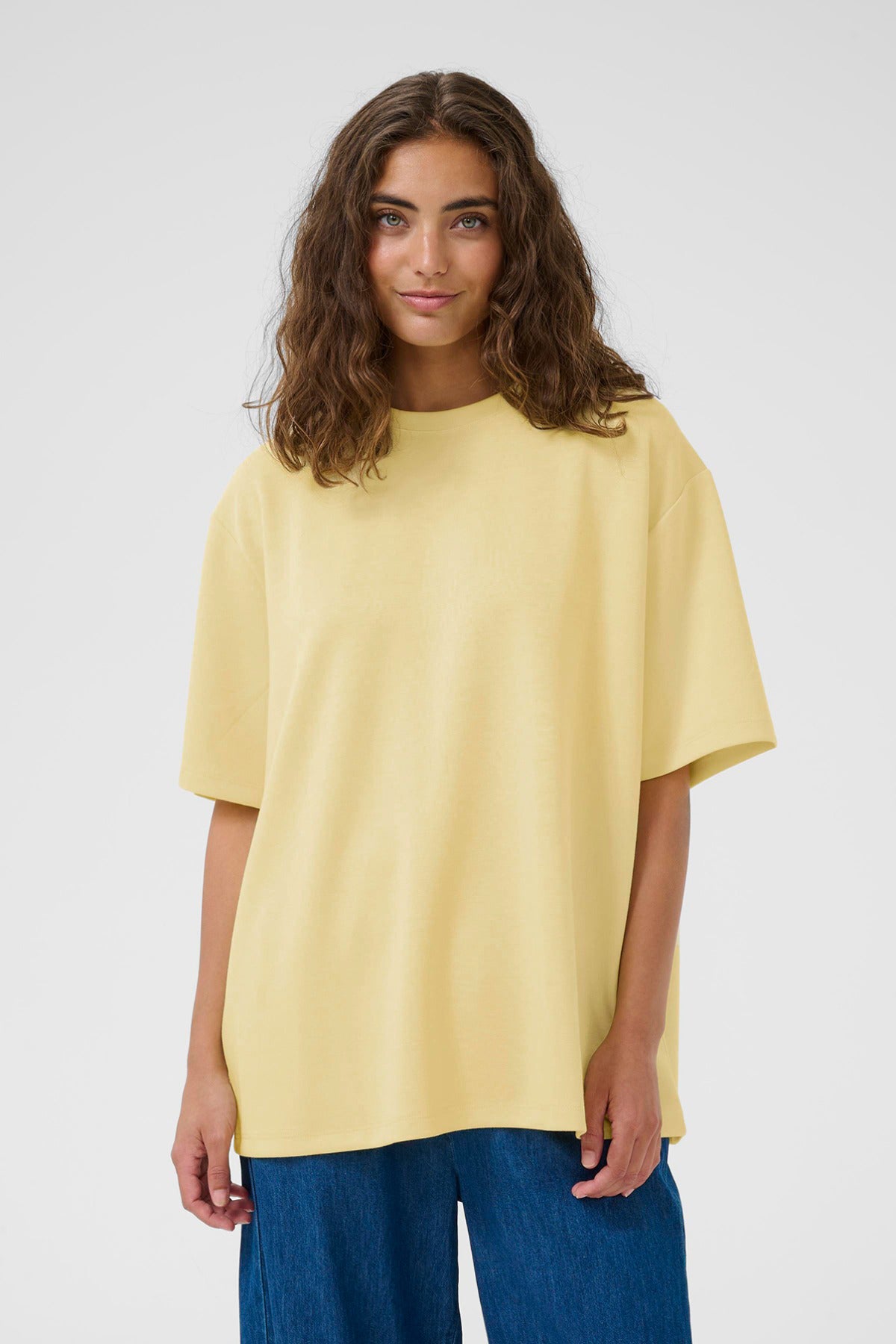 Oversize t-shirt i lysegul med rund hals og korte ærmer, løs pasform.