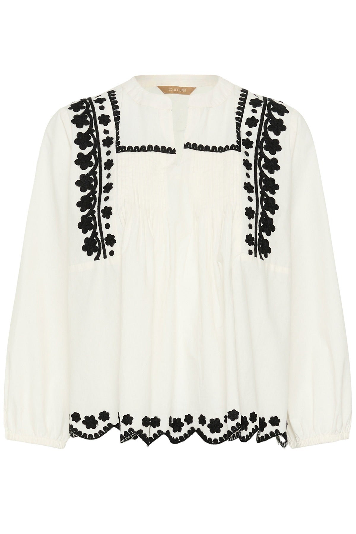 Hvid skjorte med sort broderi, rund hals og let plisseret front, lange ærmer.