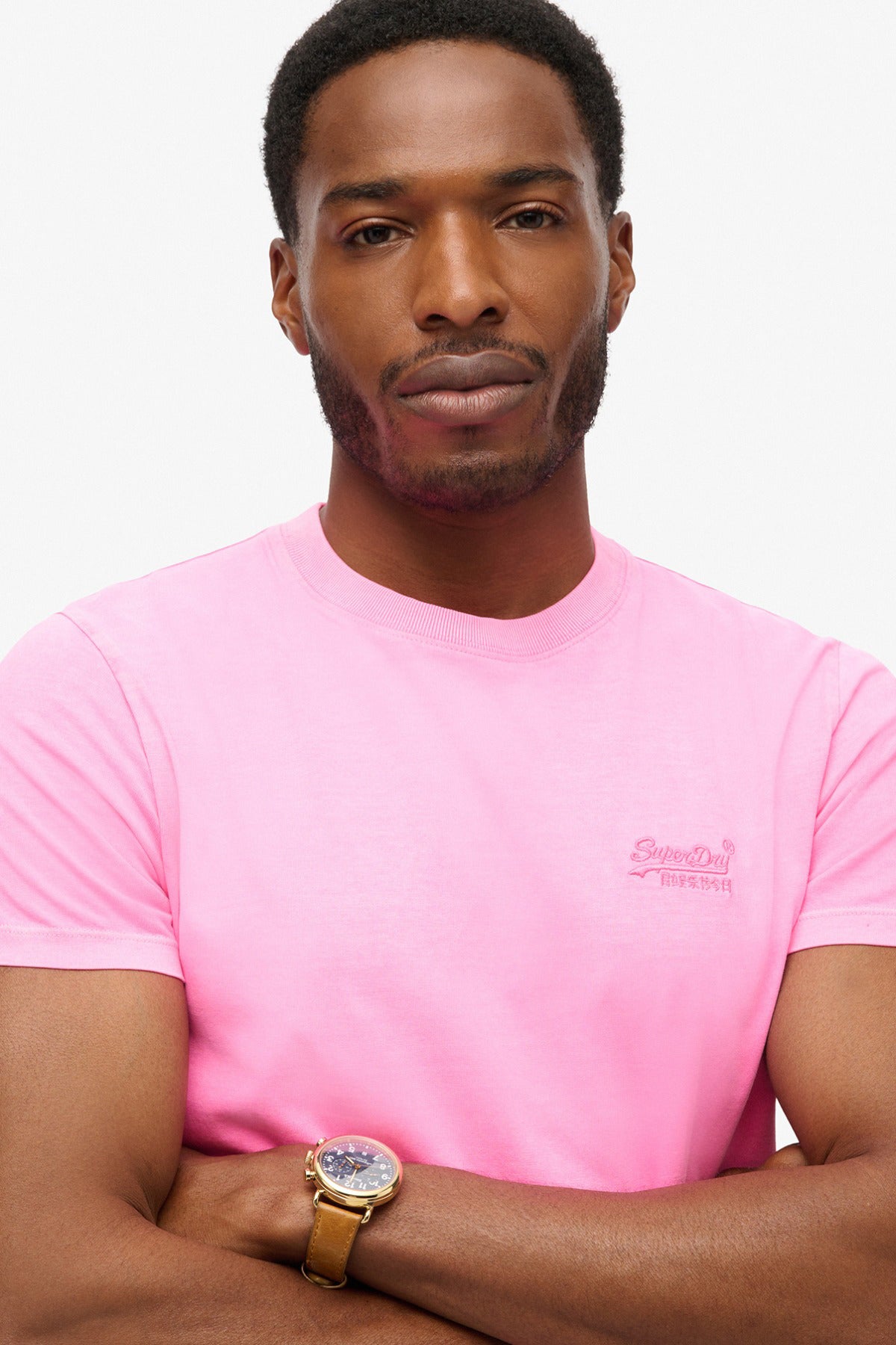 Neon pink t-shirt med rund hals og diskret logo broderet på brystet.